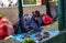 Indigenous senior woman sitting on the ground and selling vegetables