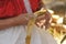 Indigenous woman`s hands wrapping tamale in corn husk