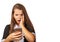 Indignant teen girl looks at smartphone display