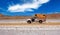 Individual atacama desert adventure travel - One lonely 4x4 camper truck in remote desert dry arid landscape - Maricunga salt