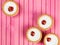 Individual Bakewell Tarts On A Pink Background