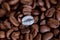 Individuality, standing out from a crowd concept, close up of a single bright, gold coffee bean over many dark ones with copy spac