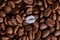 Individuality, standing out from a crowd concept, close up of a single bright, gold coffee bean over many dark ones with copy spac