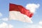 Indonesia flag blowing under blue sky
