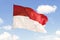 Indonesia flag waving under blue sky