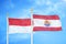 Indonesia and French Polynesia two flags on flagpoles and blue cloudy sky