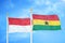 Indonesia and Ghana two flags on flagpoles and blue cloudy sky