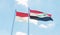 Indonesia and Iraq, two flags waving against blue sky