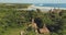 Indonesia long-held tradition village, ornate roof at sand beach aerial view. Extraordinary houses