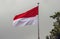 Indonesia and Monaco national flag with white cloudy sky background