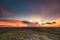 Indonesia sunset, green hills landscape under colorful sky in evening Wild Sumba Island nature scene