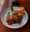 Indonesian Balinese spicy roasted duck with cone rice on banana