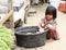 Indonesian barefoot child working