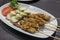 Indonesian Chicken Satay on a white plate