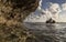 Indonesian farmer carrying seaweed collected from his sea farm to house for drying in morning, Nusa Penida, Indonesia