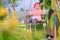 An Indonesian girl is playing on a swing in a kindergarten