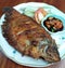 Indonesian Grilled Gourami Fish or Ikan Gurame Bakar with spicy sambal.