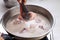 Indonesian Home Cooking Process, Female Hand Add Chicken Thigh Drumstick to the Pan using Tongs, Making Indonesian or Thai Style