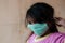 Indonesian little girl wearing surgical mask to protect herself from diseases outbreak pandemic. Illustration of health care or