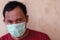 Indonesian man wears a medical face mask