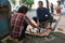 Indonesian men playing chess in the street.