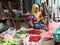 Indonesian muslim women vegetable seller wearing a veil and selling vegetable in the market at Muara Angke harbor