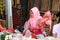 Indonesian muslim women vegetable seller wearing a veil and selling vegetable in the market at Muara Angke harbor