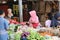 Indonesian muslim women vegetable seller wearing a veil and selling vegetable in the market at Muara Angke harbor