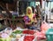 Indonesian muslim women vegetable seller wearing a veil and selling vegetable in the market at Muara Angke harbor