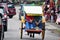 Indonesian people ride and bike rickshaw trishaw on street for bring foreign travelers travel visit for tour local bazaar around