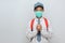 Indonesian Senior Student wearing uniform and protection face mask against coronavirus doing pray for corona virus is quickly