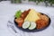 indonesian style yellow rice with chicken and side dishes in black plate