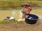 Indonesian woman does laundry in unsafe water canal