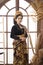 Indonesian woman standing black Balinese Kebaya against large window background