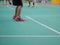 Indoor badminton court with the player legs