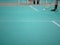Indoor badminton court with the player legs