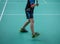 Indoor badminton court with the player legs