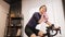 Indoor cycling. Woman cyclist is wiping face with towel during indoor cycling training on exercise bicycle at home. Female athlete