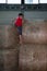 Indoor Hay Bale Obstacle Running Contest: People Climb Bale with Rope
