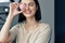 Indoor image of young woman smiling with favorite beauty product