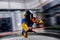Indoor. Man fly in wind tunnel. Indoor skydiving in blue yellow suit. New fly sport.