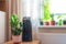 Indoor ornamental deciduous plants on the windowsill table in the apartment with a steam humidifier, thermometer to measure air