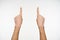 Indoor photo of pretty woman`s hands keeping forefingers raised while pointing upwards, isolated over white background while