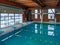 Indoor pool with turquoise water and wooden interior with lines for professional swimming practice and training for a healthier