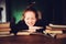 Indoor portrait of beautiful redhead woman learning or reading books in university