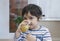 Indoor Portrait cute little boy drinking home made orange juice from glass on after finished breakfast, Healthy 4-5 year old boy