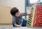 Indoor Portrait preschool boy playing in kid club, Child having fun playing colorful toys in kid playroom. Kid boy playing with