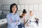 Indoor portrait of successful asian it-specialist standing with arms crossed and smiling. African female office worker