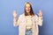 Indoor shot of amazed positive Caucasian teenager girl wearing baseball cap and jacket, raised her arms, rejoicing, posing