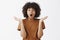 Indoor shot of excited and impressed good-looking stylish young african american female student in brown t-shirt gasping